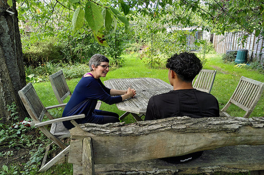 An image of two people outdoors talking